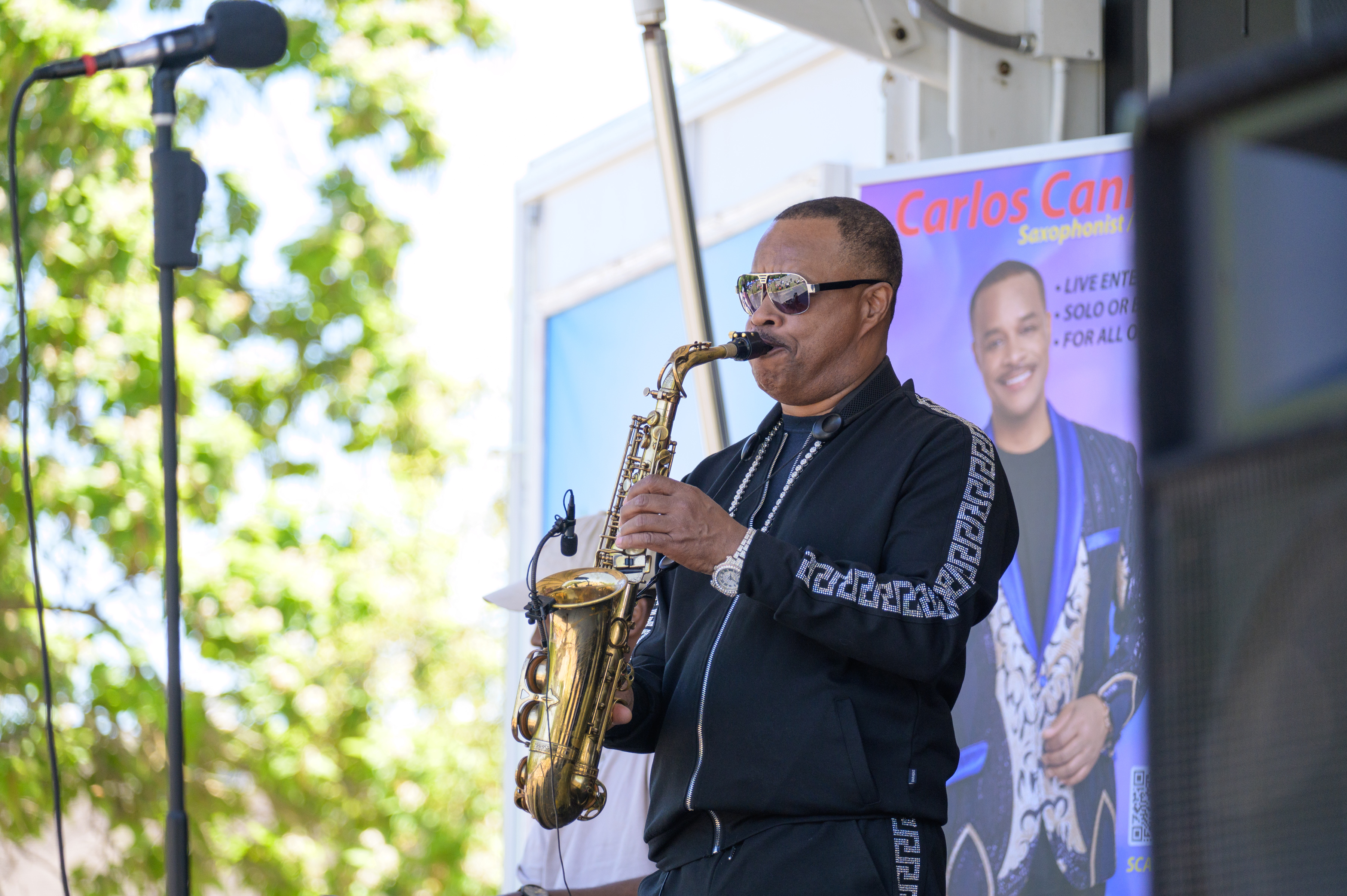 Carlos Canon performing on saxophone on outdoor stage