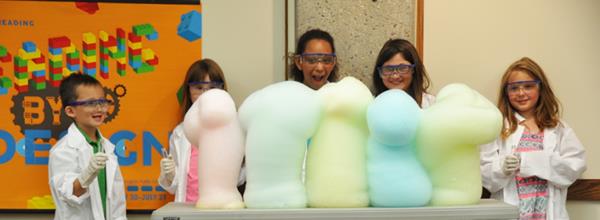 group of young student scientists with giant foam puffs