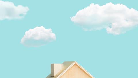 blue sky, clouds, top of model house peeking into frame