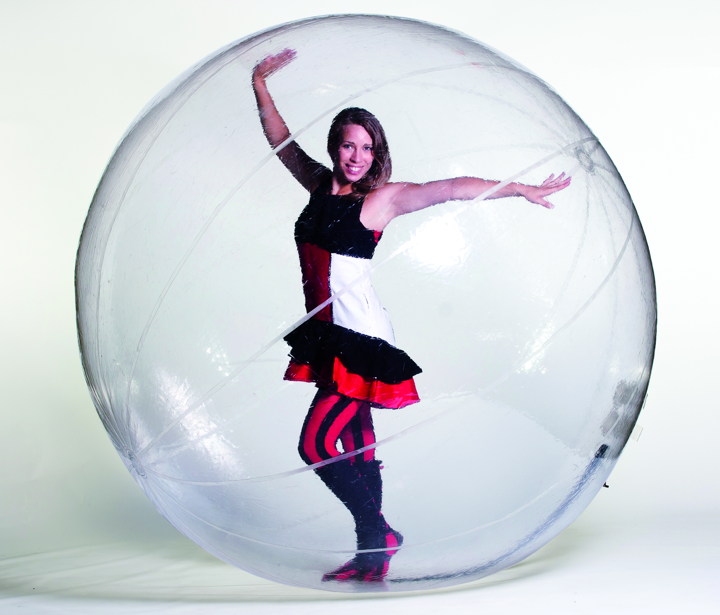 woman posing in costume inside a clear hamster ball